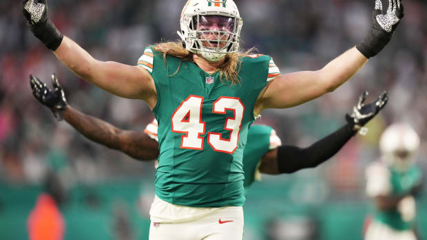Miami Dolphins linebacker Andrew Van Ginkel (43) and linebacker David Long Jr., rear, celebrate a sack against the Dallas Cowboys during the first half of an NFL game at Hard Rock Stadium in Miami Gardens, Dec. 24, 2023.